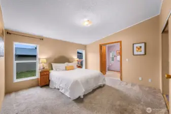 The primary suite is on the opposite side from bedroom #2 and #3 for complete privacy and is HUGE!  Closet doors to your right, bathroom seen at center.