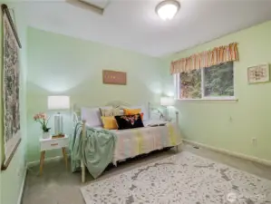 The second bedroom on the top floor has a view of the back yard.