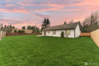 Another view of your fully fenced yard, with a nice patio
