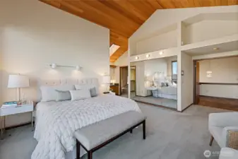 Primary Suite with walk-in closet, double vanity, tub & shower., and shelving behind full mirrors.