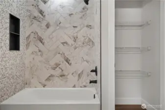 Main Hall Bath Shower w/Custom Tile and Black Accents. Linen Shelving is already in place!