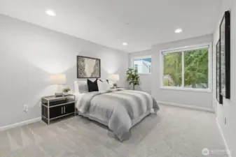 Primary bedroom with ensuite bathroom & walk-in closet (staged)