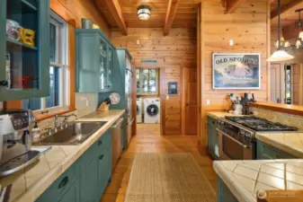 KITCHEN LOOKING TOWARDS THE WALK IN PANTRY AND LAUNDRY/MUDROOM WITH EXTRA FRIDGE, SINK AND STORAGE