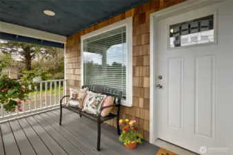 This cozy cottage welcomes you in with a covered front deck.