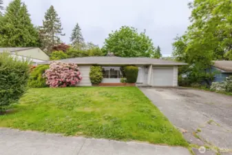 Nestled on a peaceful street with a lush backdrop of mature trees.