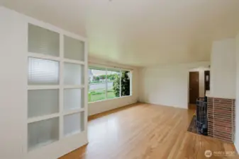 A built-in glass block partition adds a unique design element and gently separates the entry from the main living space while maintaining an open, airy feel.