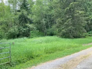 The property rises up a hill in the background.