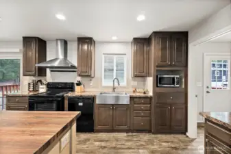 Kitchen sink window overlooks backyard area.