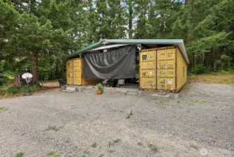 Custom roofing installed over container storage/outdoor area.