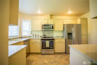Kitchen boasts plenty of storage and high quality cabinets and counters.