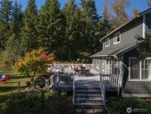 Dappled sunlight, tall evergreens, and seasonal deciduous trees make for year round enjoyment at this legacy property.