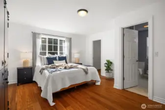 The primary bedroom is on the main floor, and includes a walk-in closet + full bathroom, with stall shower & soaking tub.