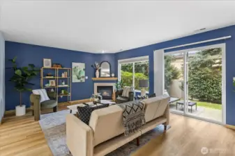 open living room featuring a cozy gas fireplace, creating a warm and comfortable atmosphere. Outside, a charming and quaint patio area is also captured, suggesting an enjoyable outdoor space.