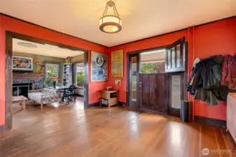 Entryway flows seamlessly into the oversized living room, showcasing the home's open layout and beautiful hardwood floors.