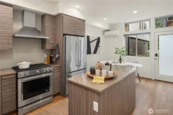 The kitchen features designer cabinets, gas cooking and a great floorplan. A mini-split provides warmth and A/C on the warm summer days.