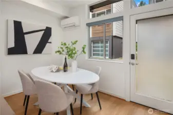 Full sized dining area just off the kitchen with overhead mini-split providing heat and A/C. The door leads to the dedicated parking spot just outside.