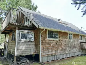 Rear and south-side of the home w/ Deck off the Primary BD upstairs.