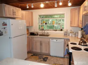 Kitchen w/ lots of counters and cabinets.