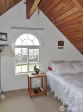 Upstairs 2nd Bedroom w/ vaulted wood ceilings.