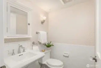 Powder room/ half-bathroom conveniently located between entry and kitchen.