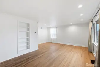 Spacious living room with built in shelving