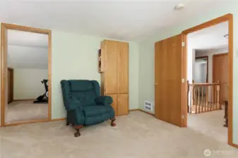 Upstairs Bedroom looking into current exercise room/flex space/playroom with attic access