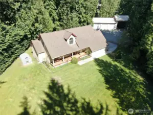 Aerial view of the home, 1,620 foot shop with RV parking and lush lot.