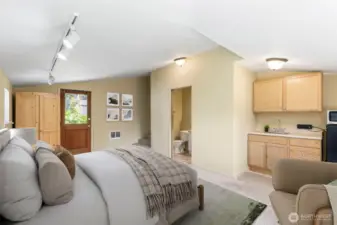 Primary bedroom has a separate entrance, 3/4 bath and mini kitchen area. Virtually staged.