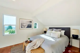 Primary bedroom with original fir flooring and en-suite and oversized closet.