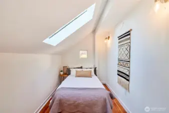 Charming 3rd bedroom with tons of natural light and original fir flooring.
