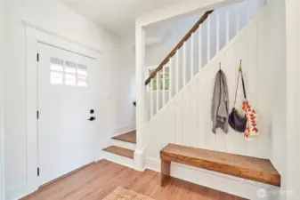 Delightful entryway with custom floating bench.