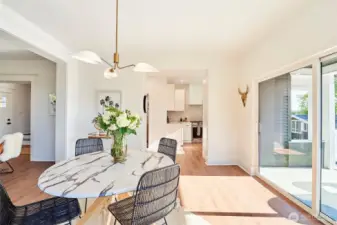 Sprawling dining room with stylish finishes opens to sun-filled deck overlooking sunset and Cascade Mountain views.