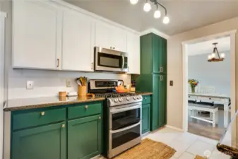 Sleek designer touches shine throughout, with a chic tile backsplash, modern cabinets, stylish hardware, and a newer range, crafting a trendy kitchen perfect for hipster culinary adventures.