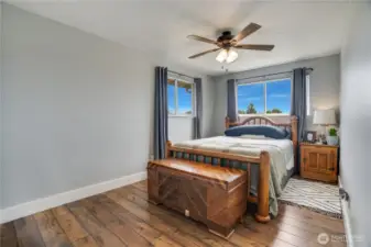 The bedroom shines with custom built-in closet organizers, maximizing space and adding a sleek, tailored touch for effortless style and storage.