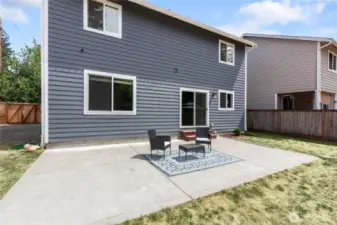 Concrete stamped patio equipped with poles for outdoor lighting.