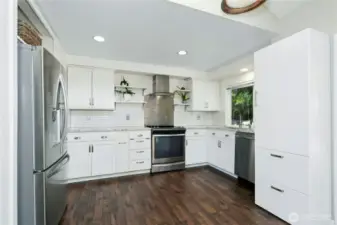 Updated kitchen with movable island and Stainless-Steel appliances