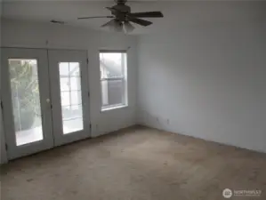 Primary bedroom. Has French doors that lead to small deck and patio.