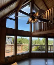 High cathedral wood ceilings give a warm welcoming feel. Ceiling fan and light keep the room comfortable. Remote controlled shades are installed.