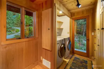 The pantry/laundry room and side entrance with storage. Accessible from the kitchen and main entrance as well.