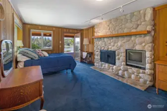 Guestroom #1 with fireplace and glass door to the covered patio.