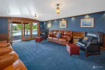 The stately family room has been beautifully finished to resemble a ship's cabin with barrel vaulted ceiling and recessed lighting. French doors lead to the covered patio.