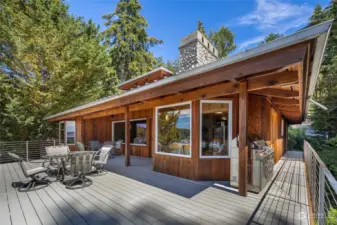 The spacious 790 sqft  view deck is partially covered. It wraps around one side of the house and has stairs down to the lower level.