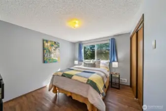 The upper level, just a few steps from the main level entry, features 3 bedrooms, and 2 full baths.  The bedrooms all enjoy laminate wood flooring for easy cleaning and a handsome style.  Ample space here for a queen bed.