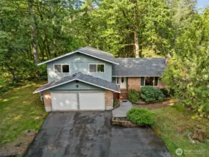 This handsome home offers privacy, lawns ample parking, decks and a practical, entertainment or work-from-home-friendly floor plan