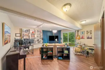 A few short steps down from the main entry, find the huge bonus space with easy-care wood laminate floors.  A true multi-purpose area for your office set up, big screen, or your band! Slider to patio too. Plumbed for wet bar.