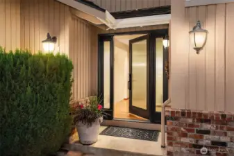 Expansive front glass door and side lights greet your guests