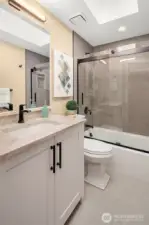 Upstairs bathroom coordinates with primary bath design for a serene space.
