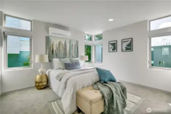 Spacious primary bedroom with plush carpet and blackout blinds...