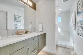 Primary bath with 3-cm quartz countertops, dual lavs, under-cabinet lighting, large shower, and heated floors