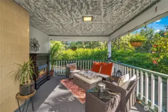 Tranquil covered porch space surrounded by lush greenery, offering a peaceful retreat in every season. With room to create your ideal seating or dining arrangement, this versatile area is perfect for enjoying morning coffee, reading a book, or simply relaxing while taking in the serene outdoor views.